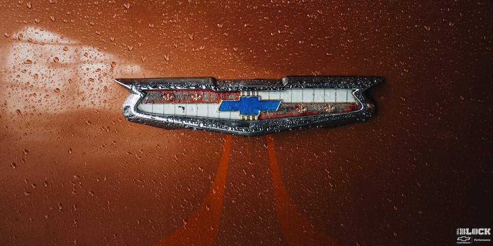 Close-up of the Chevrolet Emblem on an Orange 1955 Handyman Wagon