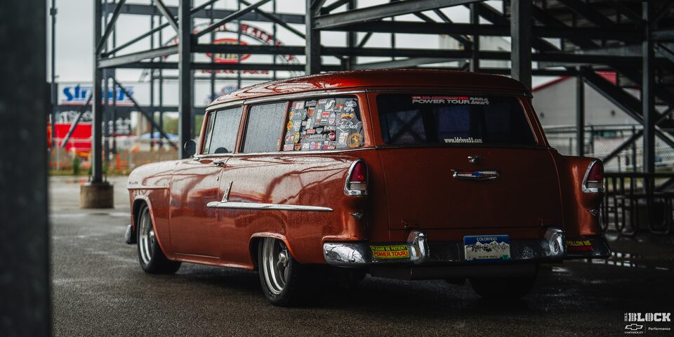 Three Quarters Rear View of a Wet 1955 Chevy Handyman Wagon under Cover