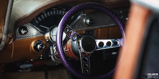 A Shot of a Violet Colored Steering Wheel Seen through the Window of a 1955 Chevy Handyman Wagon