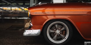 Side View of the Silver Chevrolet Emblem Embedded on the Front Side of an Orange 1955 Chevy Handyman Wagon