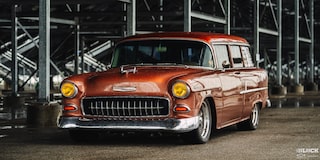 Three Quarters View of an Orange Chevy Handyman Wagon under the Shade on a Rainy Day