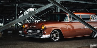 Three Quarters View of an Orange Chevy Handyman Wagon under the Shade 