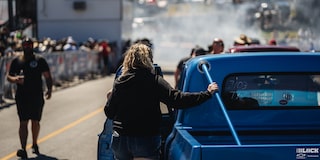 A Woman Places her Hand on a Chevy C10 Truck at a Racing Event
