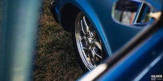 A Shot of the Front Left Tire Seen through the Front Window of a 1967 Blue Chevy C10 Truck