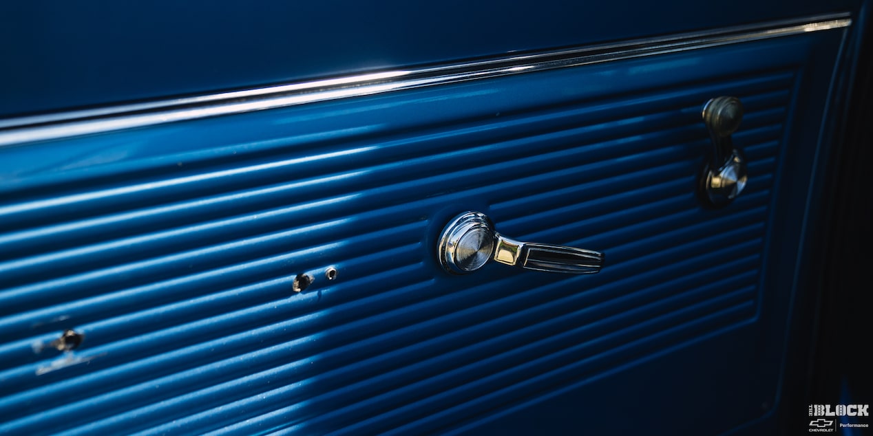 Close-up of the Window Handle in a Blue 1967 Chevy C10 Truck Seen from the Interior