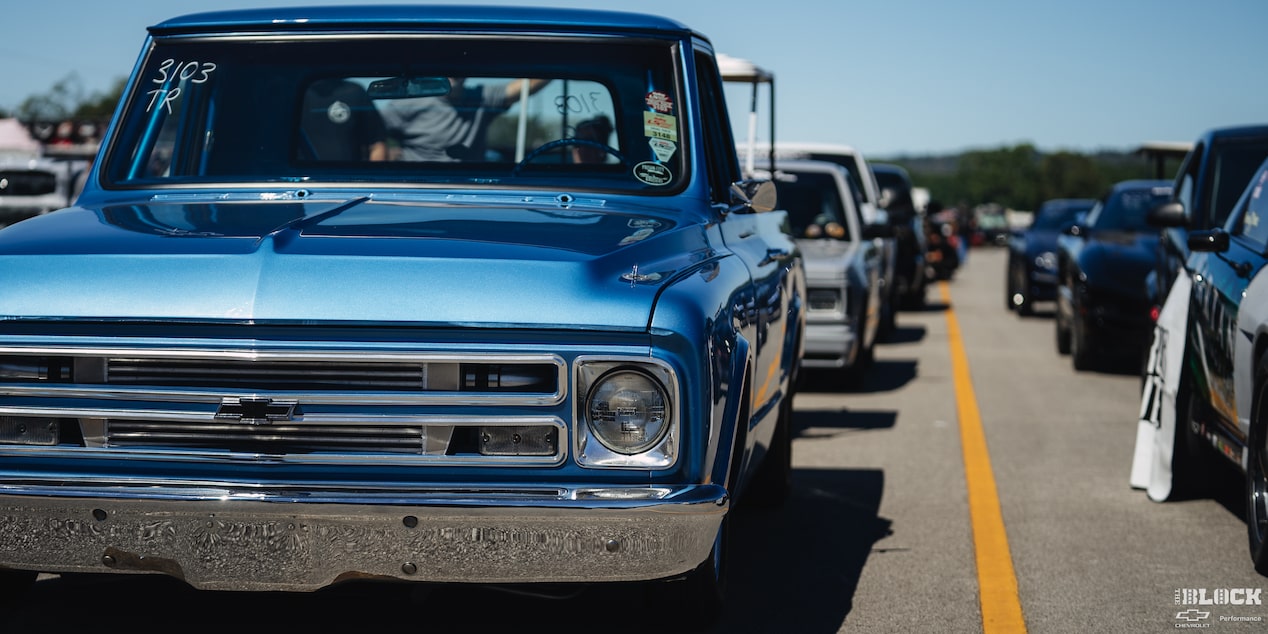 Eye Level View of a 1967 Blue Chevy C10 Truck Parked in a Row of Vehicles