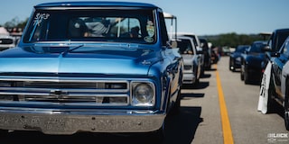 Eye Level View of a 1967 Blue Chevy C10 Truck Parked in a Row of Vehicles
