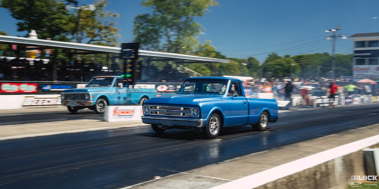 Three Quarters View of Two Blue 1967 Chevy C10 Truck Racings on a Sunny Day