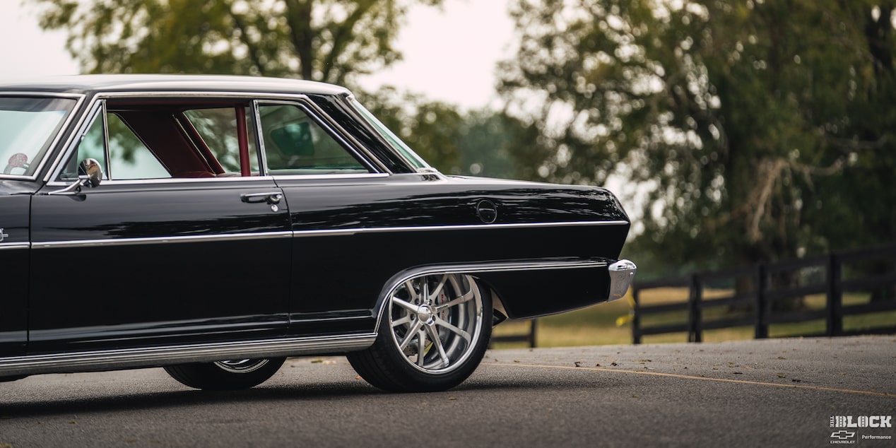  Side View of a Black 1964 Chevy Nova on Left Side of the Frame on the Road